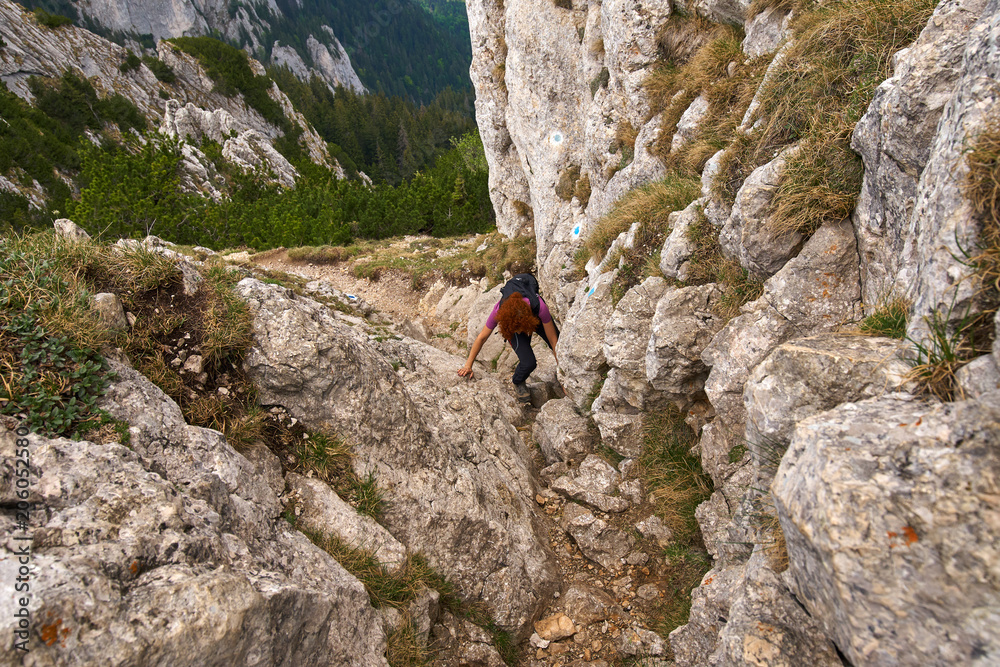 Woman climbing in the mountains