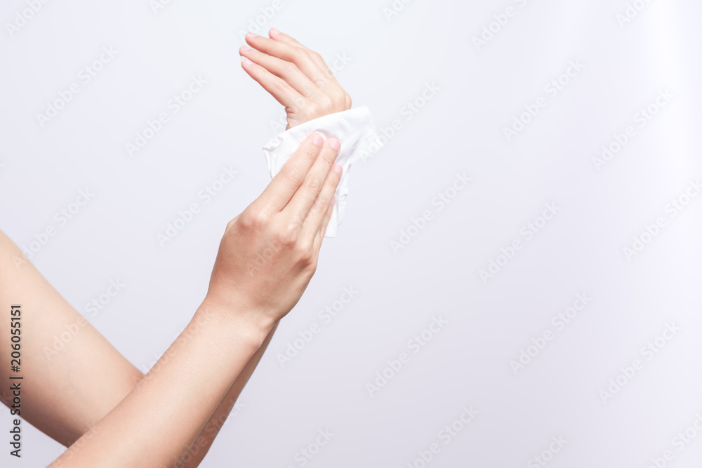 Woman cleaning her hands with white soft tissue paper. isolated on a white backgrounds Woman cleaning her hands with white soft tissue paper. isolated on a white backgrounds