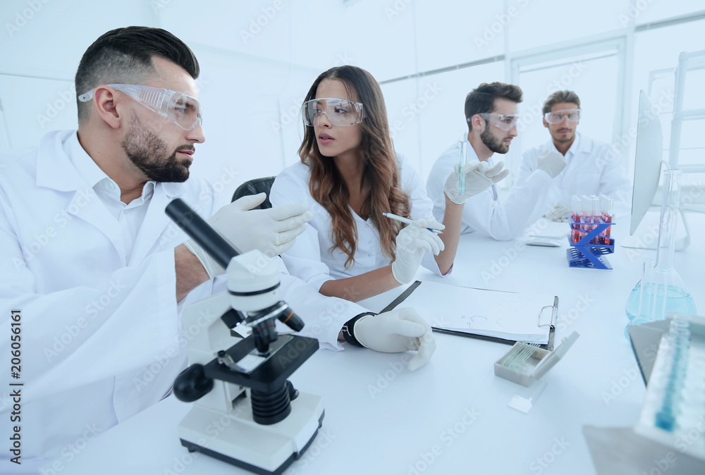group of young scientists discussing the results of a study group of young scientists discussing the results of a study