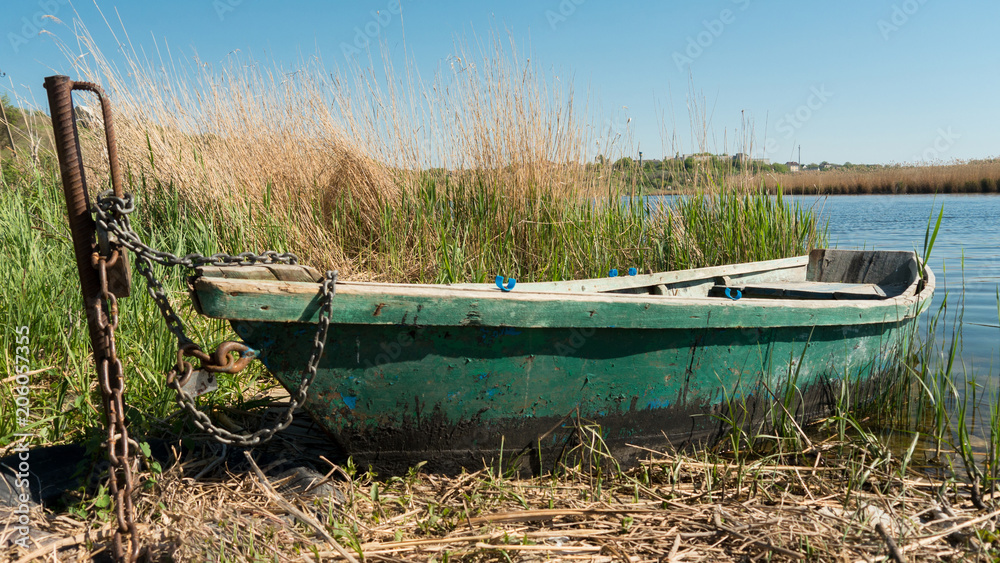 Green fishing the boat near the river. Green fishing the boat near the river.