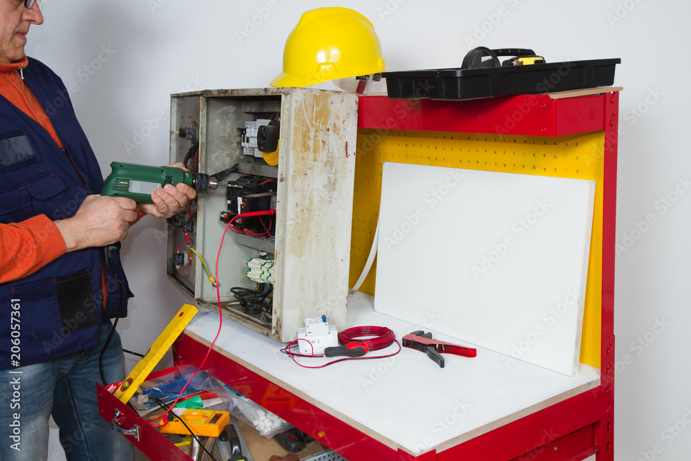 Fototapeta premium electrician fixing electrical system with different tools