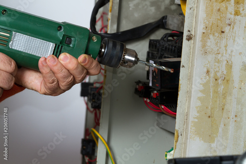 electrician fixing electrical system with different tools