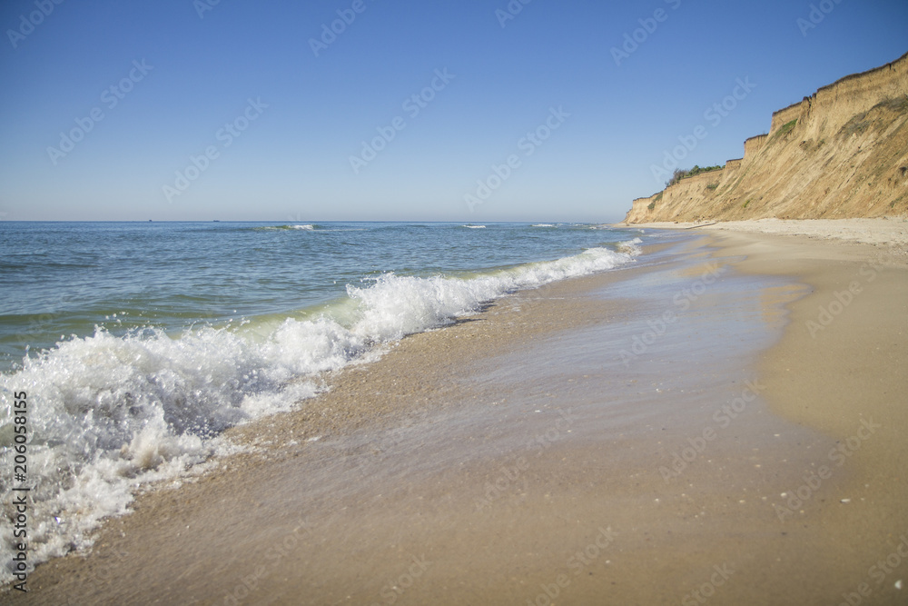 The deserted fairy tale beach with golden sand, beautiful sky and turquoise water on the shores of ocean. The deserted fairy tale beach with golden sand, beautiful sky and turquoise water on the shores of ocean.