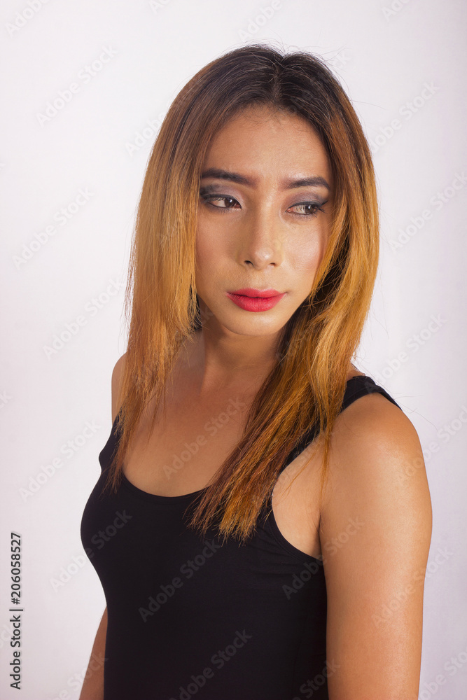 Side pose close-up of young woman with long brown hair and black blouse Side pose close-up of young woman with long brown hair and black blouse