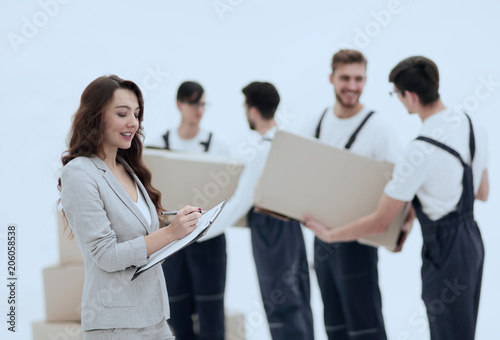 Businessman with documents, creating a stack of cardboard boxes.