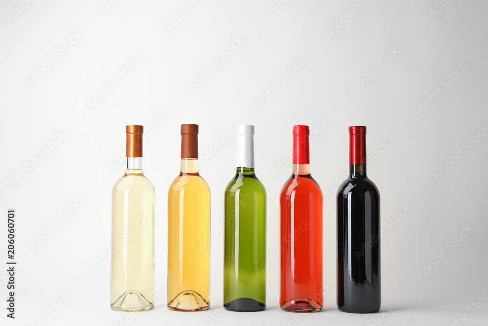 Naklejka premium Bottles of expensive wines on light background