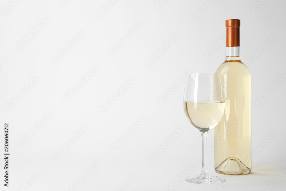 Bottle and glass of expensive white wine on light background Bottle and glass of expensive white wine on light background