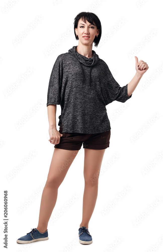 Fototapeta premium young woman posing in studio on white background, wearing brown shorts and shirt