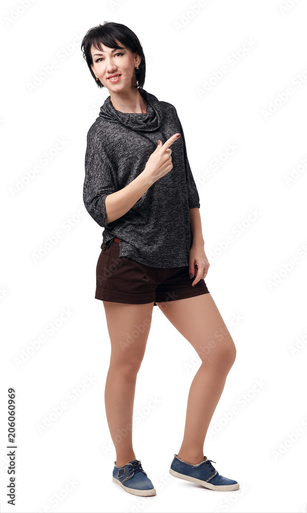 Fototapeta premium young woman posing in studio on white background, wearing brown shorts and shirt