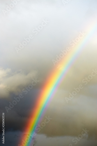 a bright rainbow on a dark stormy sky. © makam1969