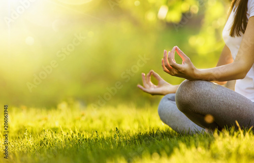 Yoga woman meditating at sunset. Female model meditating in serene harmony