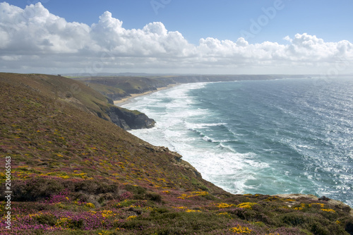 View along the St Agnes Heritage Coast towards Chapel Porth Beach on a sunny summer afternoon in Cornwall, UK