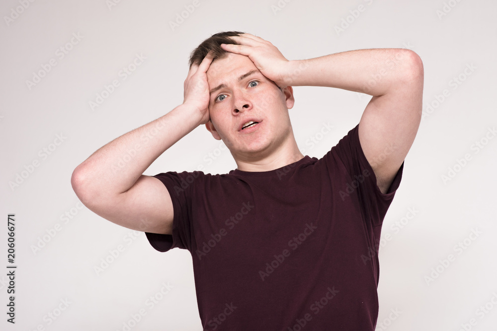 Portrait of a beautiful dissatisfied young man on a white background. Portrait of a beautiful dissatisfied young man on a white background.