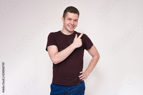 Portrait of a young handsome man on a white background showing on a product.