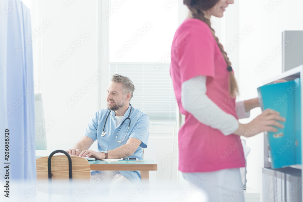 Fototapeta premium Smiling gynecologist using computer