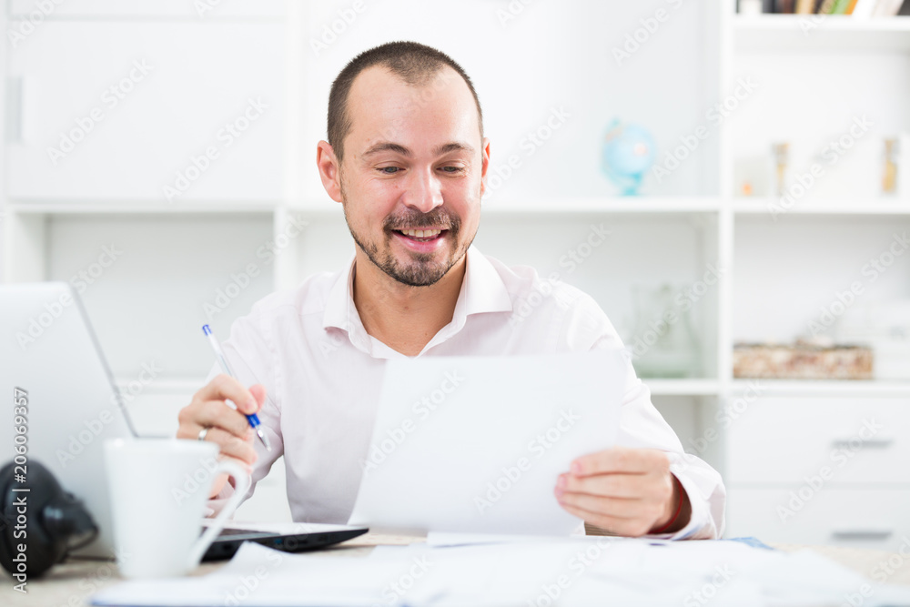 Positive young man in office