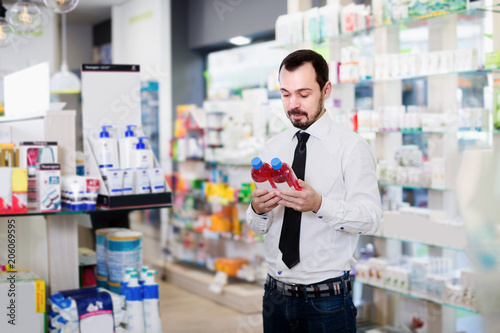 Male client looking assortment in pharmacy