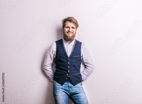 Portrait of a young hipster man in a studio. Copy space. © Halfpoint