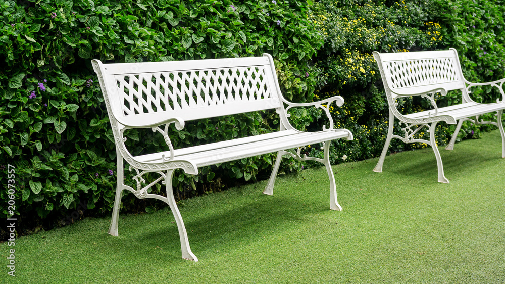 White chair for a rest in a nature garden. White chair for a rest in a nature garden.