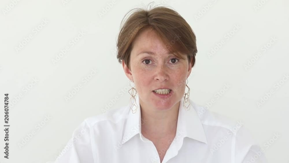 Happy attractive woman look at camera talk and smile. Woman speaks to the camera as a blog presenter isolated Happy attractive woman look at camera talk and smile. Woman speaks to the camera as a blog presenter isolated