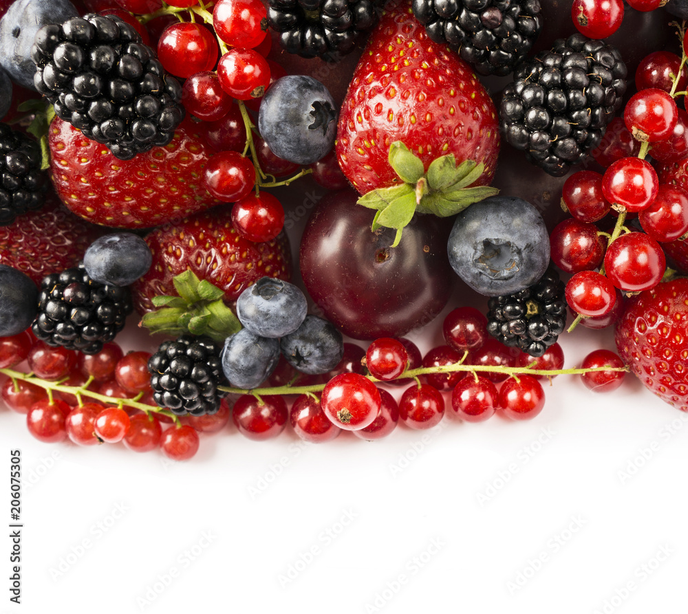 Berries and fruits with copy space for text. Black-blue and red food. Ripe blackberries, blueberries, strawberries, red currants and plums on white background. Top view. Berries and fruits with copy space for text. Black-blue and red food. Ripe blackberries, blueberries, strawberries, red currants and plums on white background. Top view.