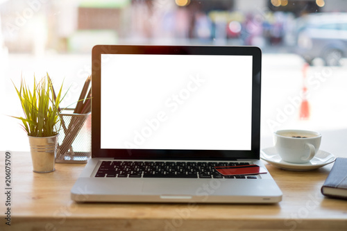 Front view of cup coffee,credit card and laptop on table in coffee shop.