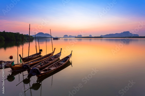 Wooden boats at sunset in Phuket,Thailand. Phuket is famous beautiful beach and the most famous travel destination of Asia.
