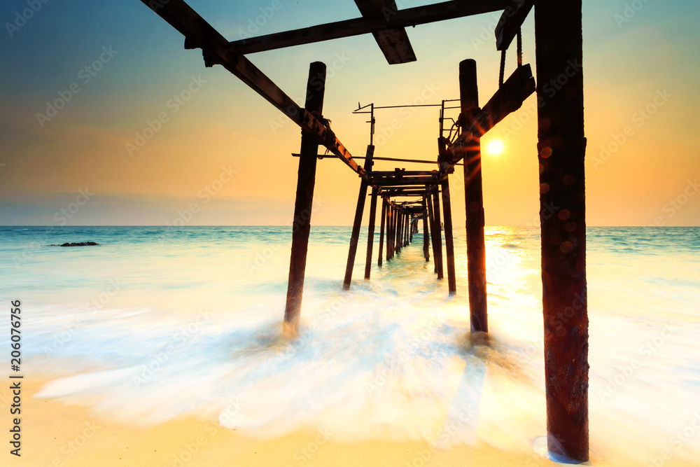 Wooden bridge on the Patong beach at sunset in Phuket,Thailand Wooden bridge on the Patong beach at sunset in Phuket,Thailand