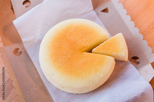 Japanese Cheesecake with seperated slice in opened paper box. Soft and sweet. photo