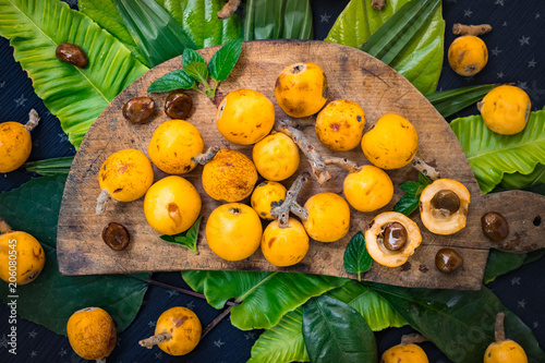 Fresh ripe mushmula or loquat fruit. Good for breakfast and desserts. Evergreen subtropical tree orange sweet and juicy fruit widely spread in Georgia, Japan, Korea, Spain and other asian countries. photo