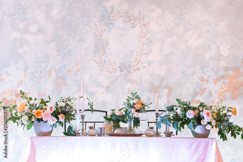 arrangement, wedding, design concept. gorgeous wedding table setting for two person decorated with great bouquets of flowers and candles in different holders. with empty space for text