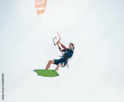 Kitesurfing Kiteboarding action photos man among waves quickly goes