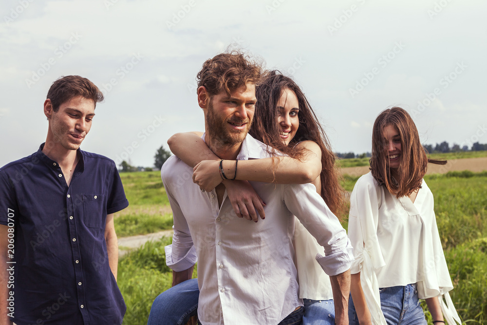 group of young handsome people walk together
