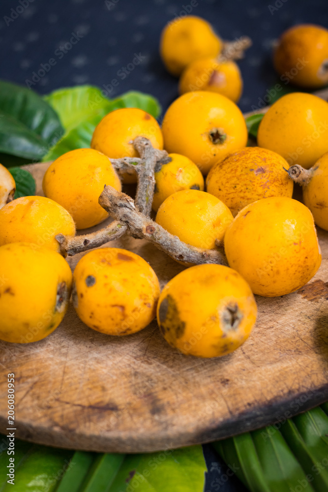 Fresh ripe mushmula or loquat fruit. Good for breakfast and desserts. Evergreen subtropical tree orange sweet and juicy fruit widely spread in Georgia, Japan, Korea, Spain and other asian countries.