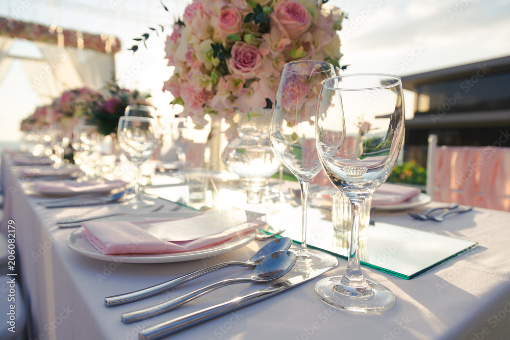 Dinner table with flower decoration in Wedding ceremony in the sunset time. Dinner table with flower decoration in Wedding ceremony in the sunset time.