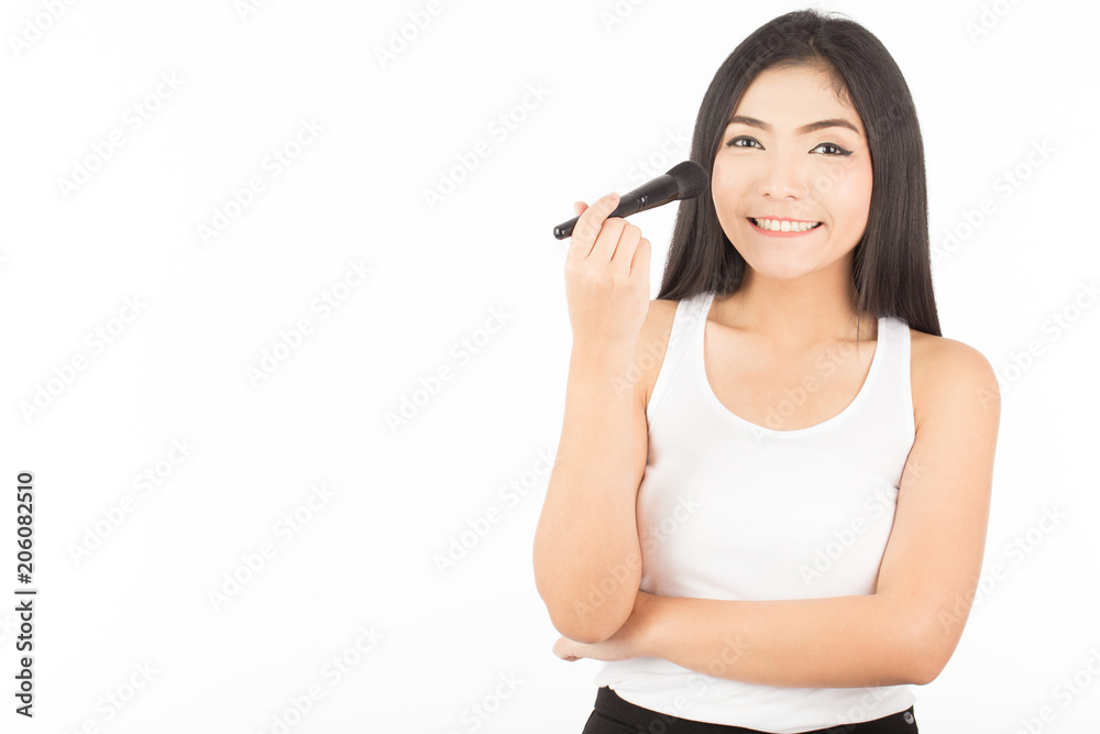 Beautiful Asian young woman smile and holding make up brush and applying on her cheek with copy space for display product,Feeling so happiness ,Isolated on white background Beautiful Asian young woman smile and holding make up brush and applying on her cheek with copy space for display product,Feeling so happiness ,Isolated on white background