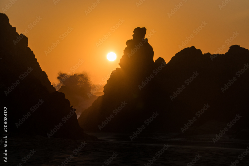 Sunset view of rocks on a hidden Praia Da Ursa  near Cabo Da Roca, Portugal