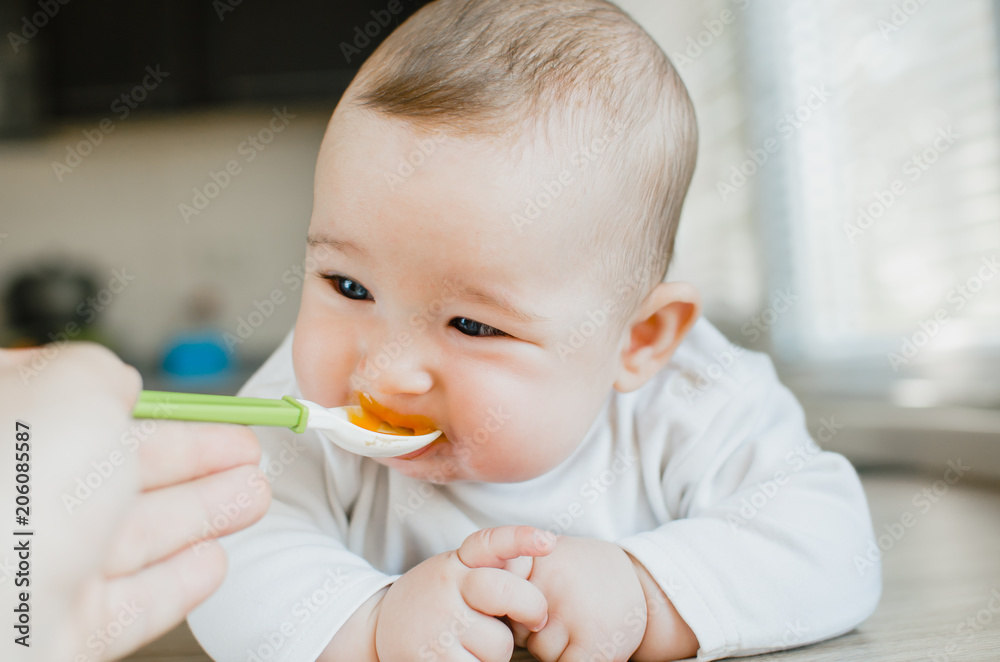 baby with blue eyes eats pumpkin puree baby with blue eyes eats pumpkin puree