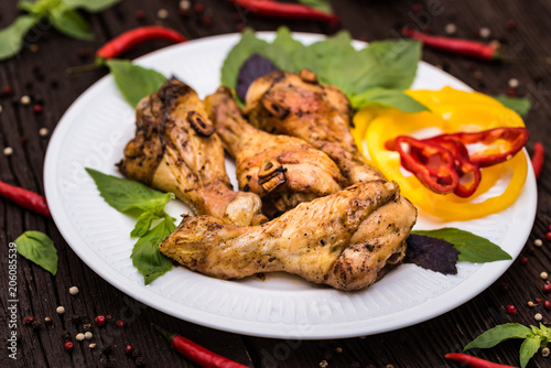 Roasted chicken quarter legs on rustic background