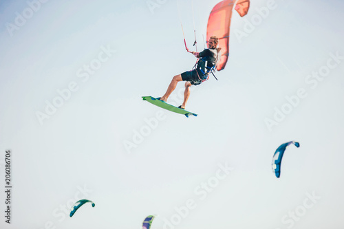 Kitesurfing Kiteboarding action photos man among waves quickly goes