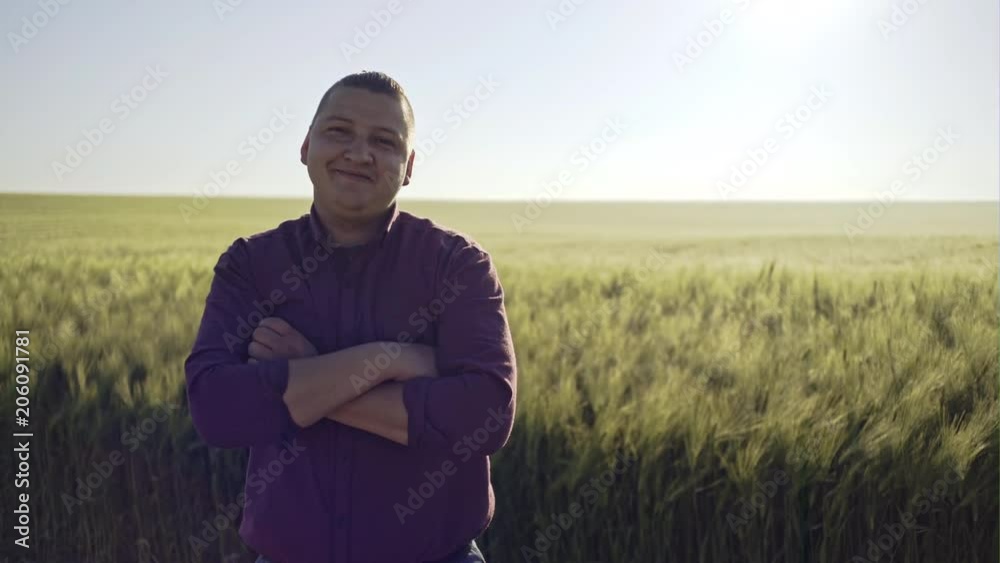 Conceived young farmer touching ripe golden wheat in field Conceived young farmer touching ripe golden wheat in field