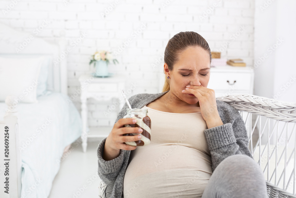 No more sweet. Sad pregnant woman sitting while carrying cocoa spread No more sweet. Sad pregnant woman sitting while carrying cocoa spread