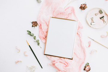 Creative wedding composition with photo frame mock up, pink blanket, flowers, eucalyptus branches and brushes on white background. Flat lay, top view stylish art concept.
