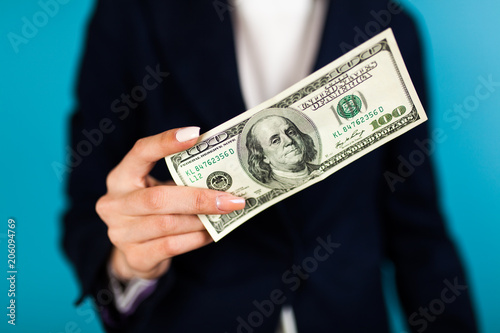 Woman holding a 100 dollar bill