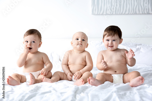 Cute little babies on bed i...