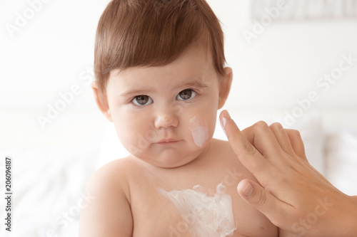 Woman applying body cream o...