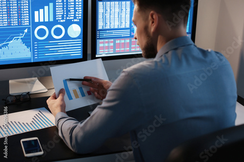 Male broker working in offi...