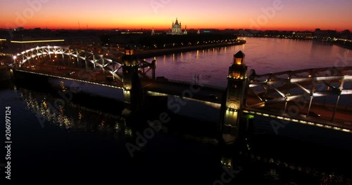 Aerial beautiful sunset view of the bridge with towers at night with the illuminated light, Saint Petersburg, Russia