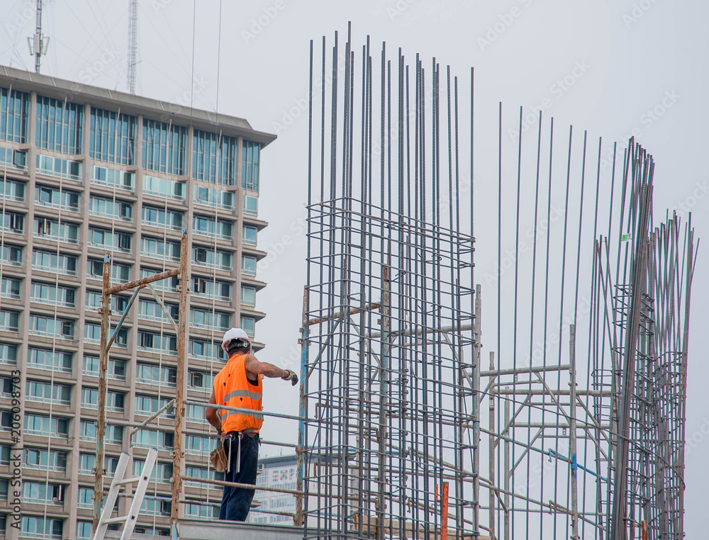 worker prepares armor for reinforced concrete