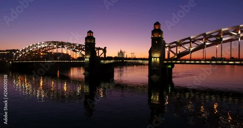 Aerial beautiful sunset view of the bridge with towers at night with the illuminated light, Saint Petersburg, Russia